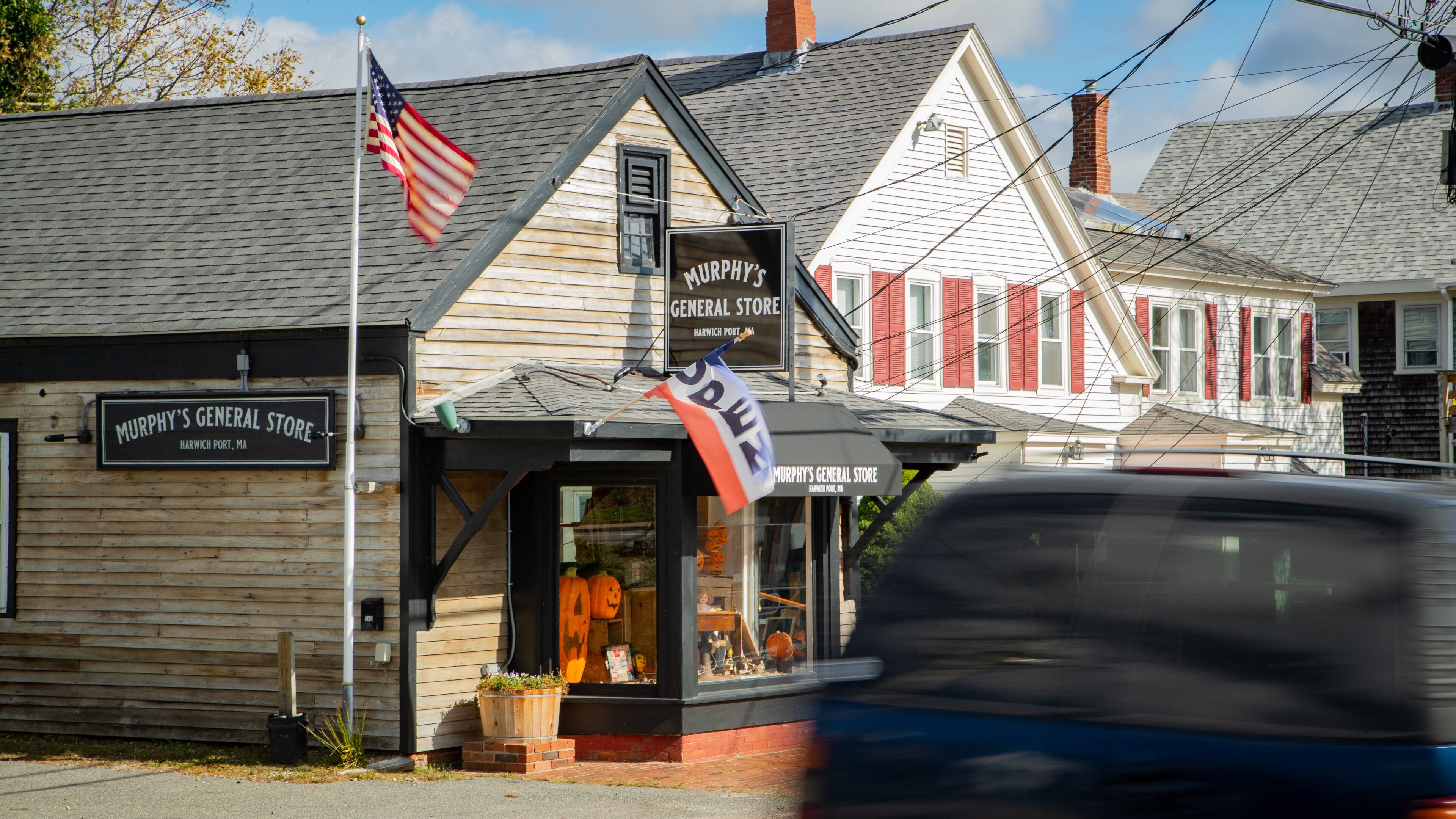 A wooden building with a sign reading "Murphy's General Store" in Harwich, MA.