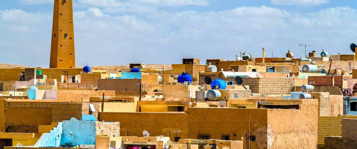 A densely packed urban area with a prominent tower and numerous water tanks.