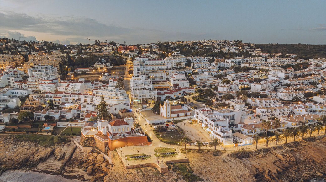Aerial view of beautiful Praia da Luz with white washed houses and Fortaleza da Luz on the cliff by the ocean, Luz, Portugal.