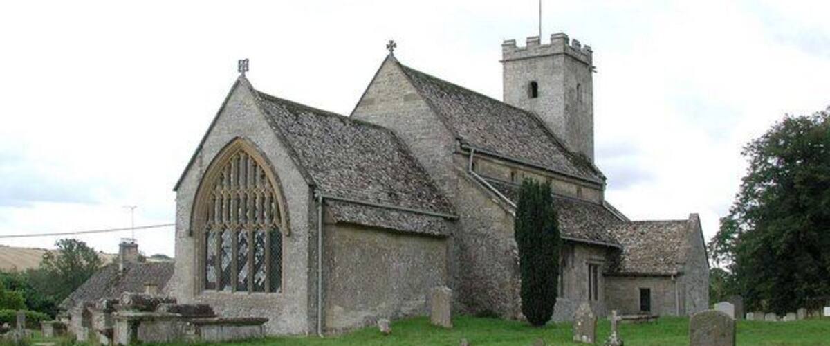 A church with a large arched window and a bell tower.