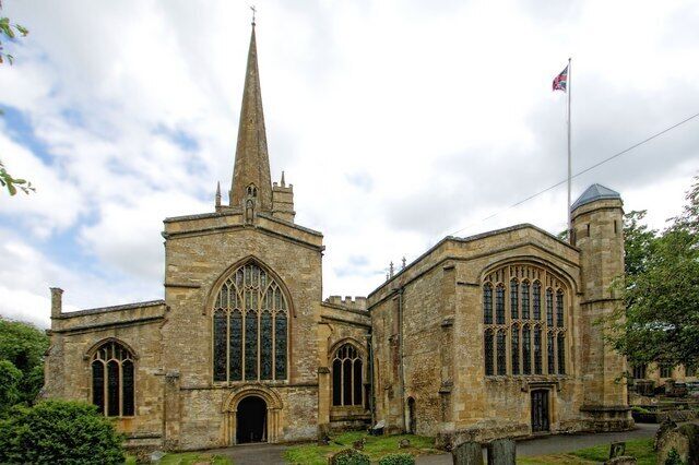 A historic church with a tall spire and arched windows.