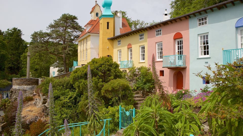 A colorful hillside with pastel houses, a church, and lush greenery.