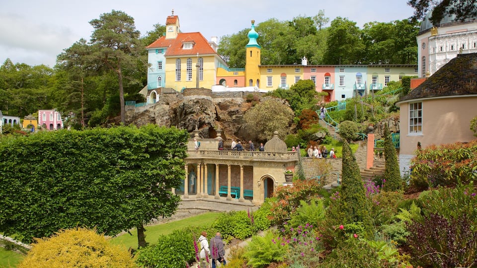 A colorful building with a red roof, a green tower, and a statue in front.
