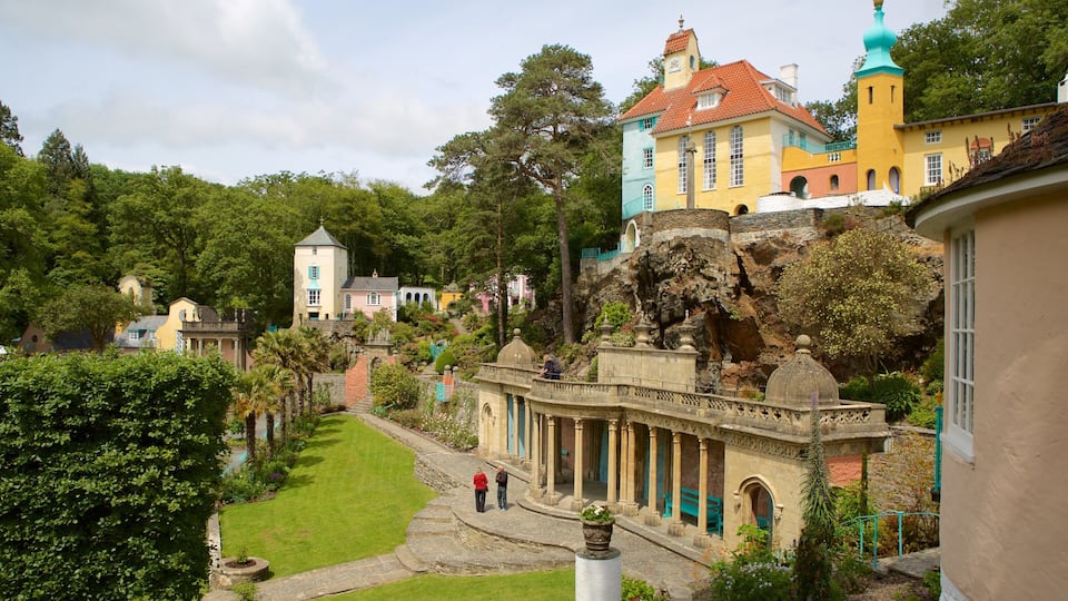 A lush garden with a variety of trees and a stone bridge.
