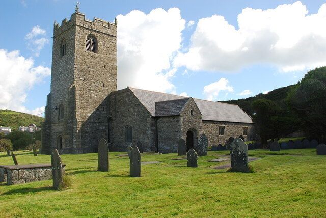 A church with a tall tower and a graveyard.