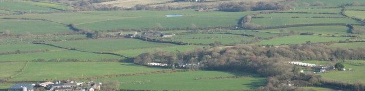 Faerdre Farm and Plas Gelliwig from Rhiw Mountain Faerdre Farm is on the left of the photo. The Caravan parks at Gelliwig form a prominent feature of the landscape as do the kettle lakes.