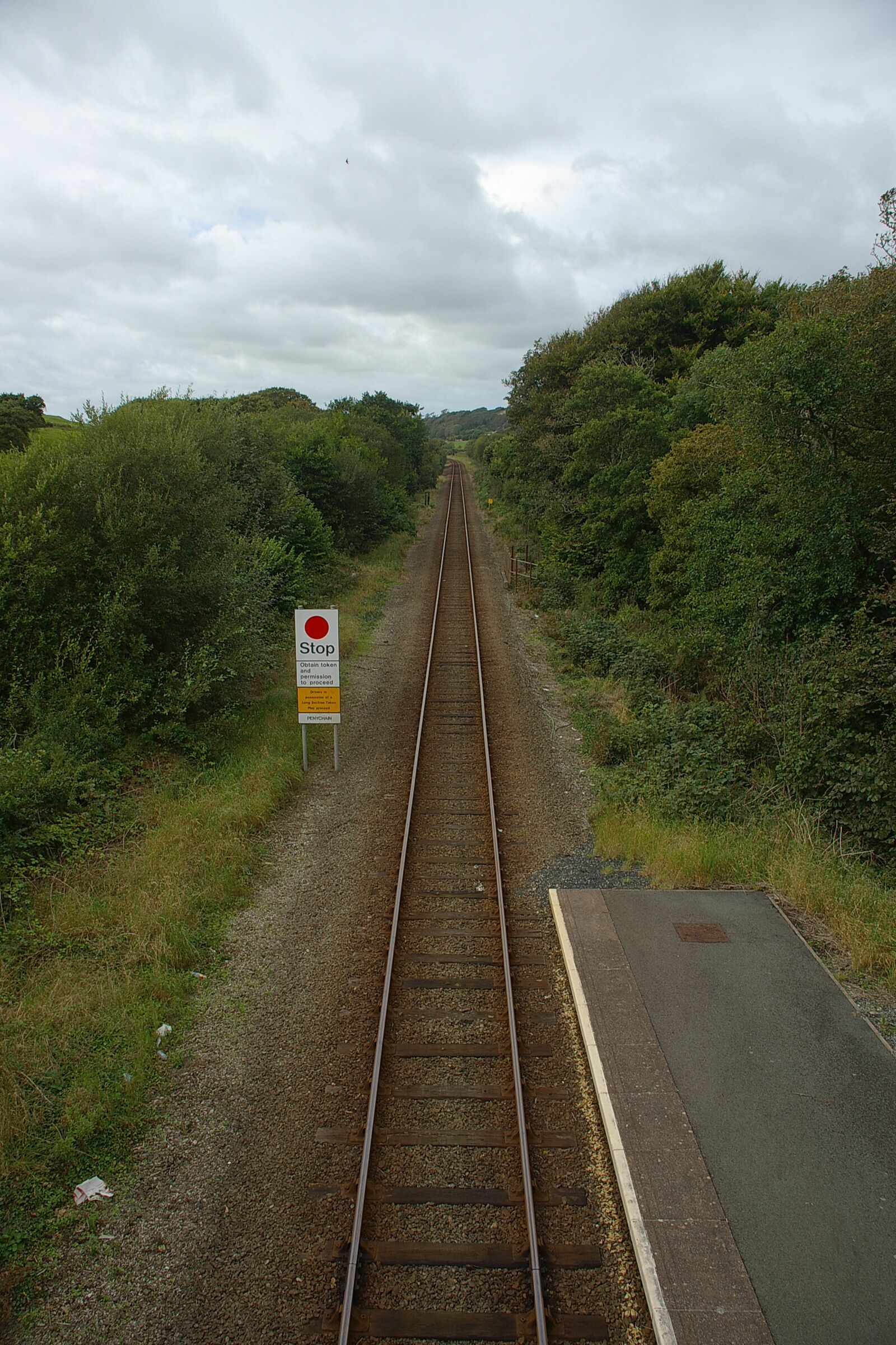A railway track with a 'Stop' sign and a 'Clearway' sign.