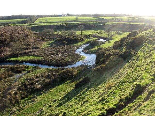 Near to Llwyndyrys, Gwynedd, Wales, Great Britain. A meandering reach of Afon Erch upstream of the elbow of capture. The 90 degree bend in the course of the river marks the point of river capture. The wind gap through which the river formerly flowed can be seen on the right. Soil creep terracetes are a prominent feature of the slope in the foreground.