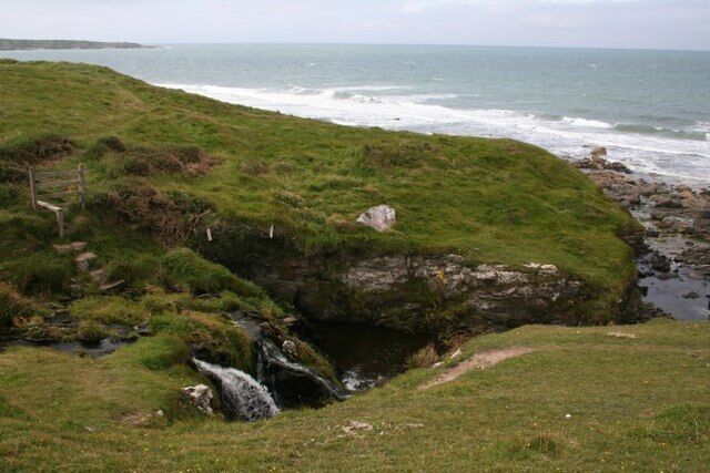 Coastal waterfall Small waterfalls on this unnamed coastal stream are marked on the 1:25000 OS map. The magnificent north coast of Llŷn stretches away beyond, the path here going up steps to a very rickety stile.