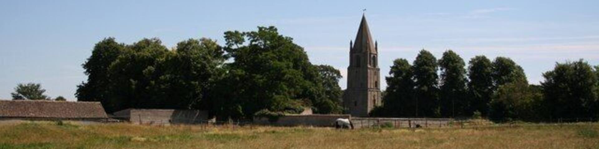 Barnack. Idyllic rural view of Barnack across a meadow to the ancient church of St.John the Baptist