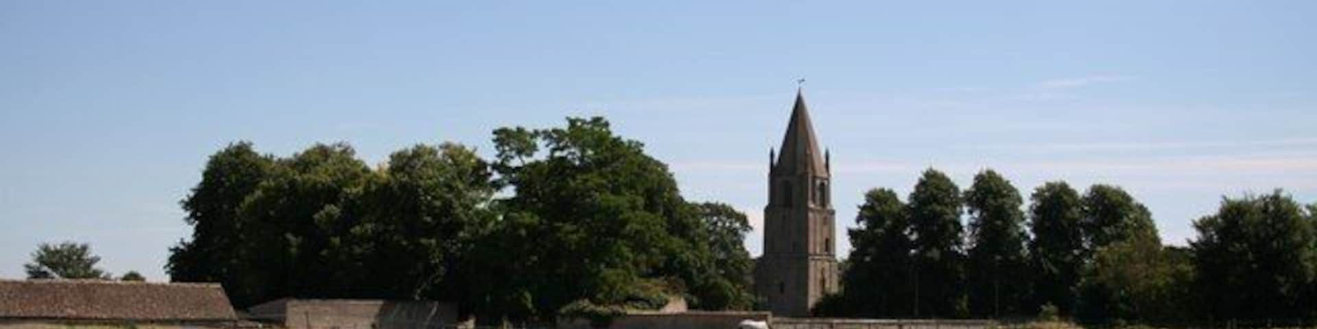 Barnack. Idyllic rural view of Barnack across a meadow to the ancient church of St.John the Baptist