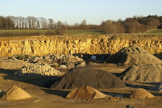 Collyweston Quarry — near Collyweston and Duddington in northeastern Northamptonshire. Originally quarried for Collyweston slate roof material (limestone shingles). A face of Jurassic limestone forms the back wall of this quarry which today mainly houses sand and gravel.