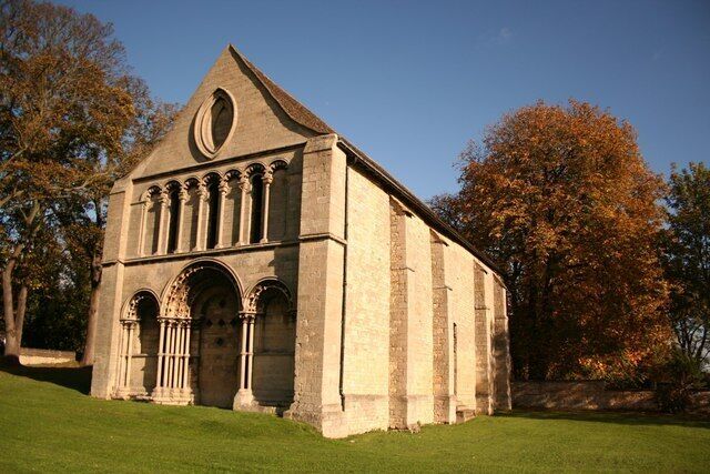 A historic stone church with arched windows and a bell tower.