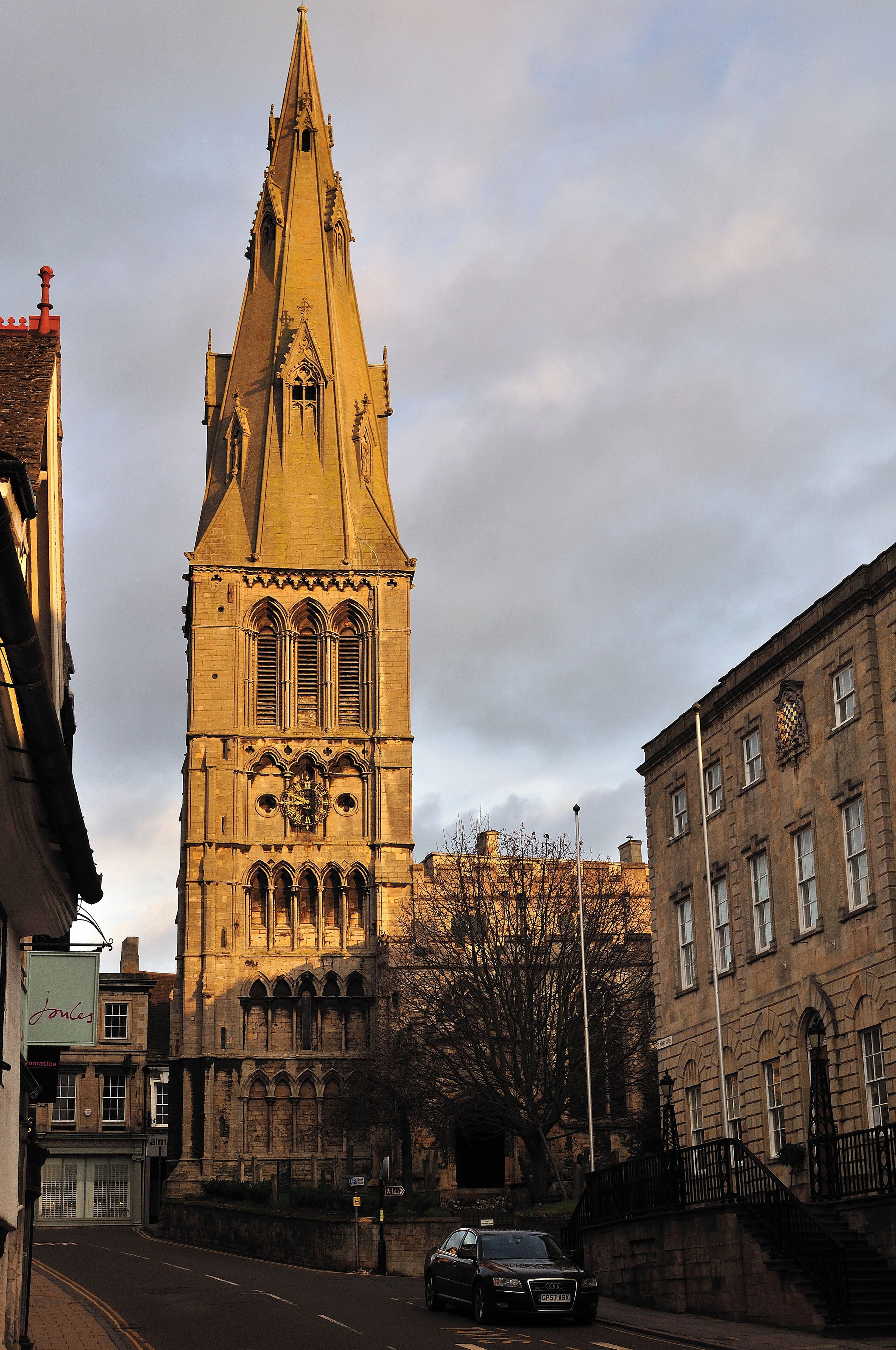 A historic church with a tall spire and a clock.