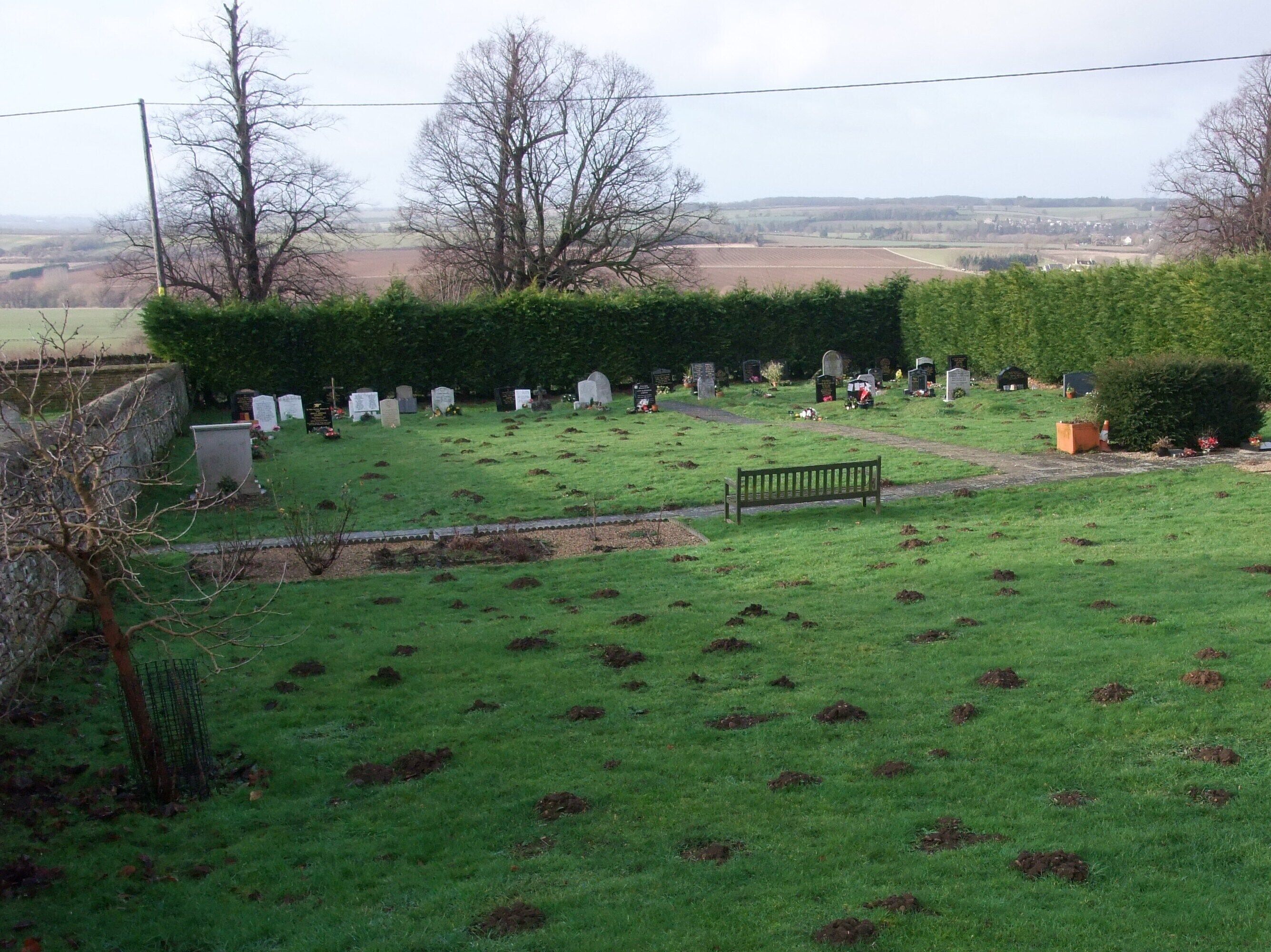 Cemetery extension, Main Road, Collyweston A new extension to the original cemetery on the other side of the wall (left). Moles appear to be the most numerous residents.