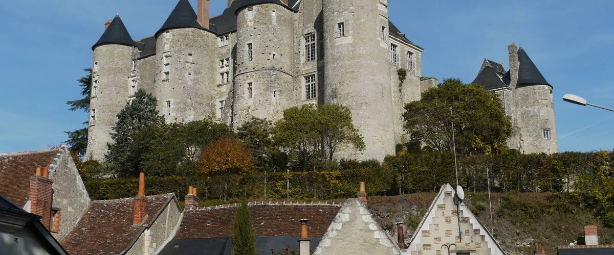 A historic castle with multiple towers and a prominent central tower.