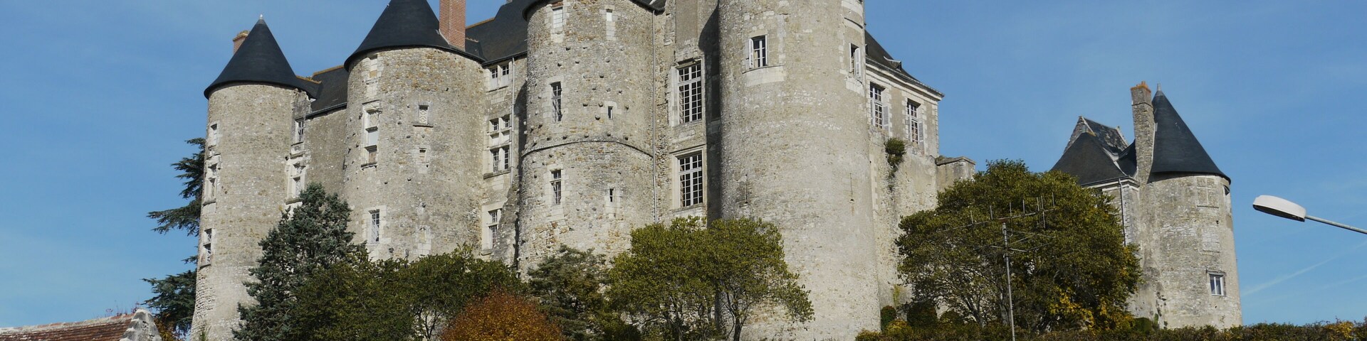 A historic castle with multiple towers and a prominent central tower.