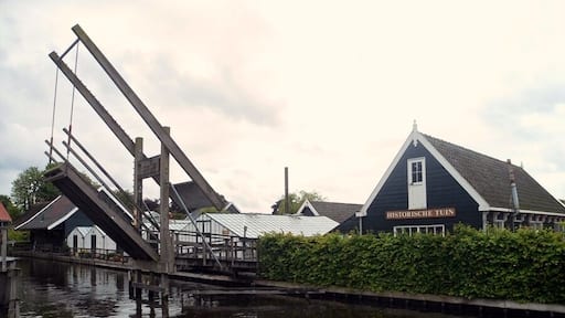 Walking through the bridge on a calm lake to the Historic Garden