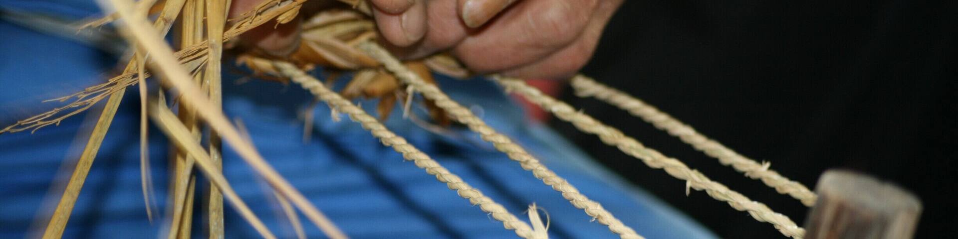 A 'Tracker' from The Shennong Stream, demonstrating the technique to make their weave sandals.