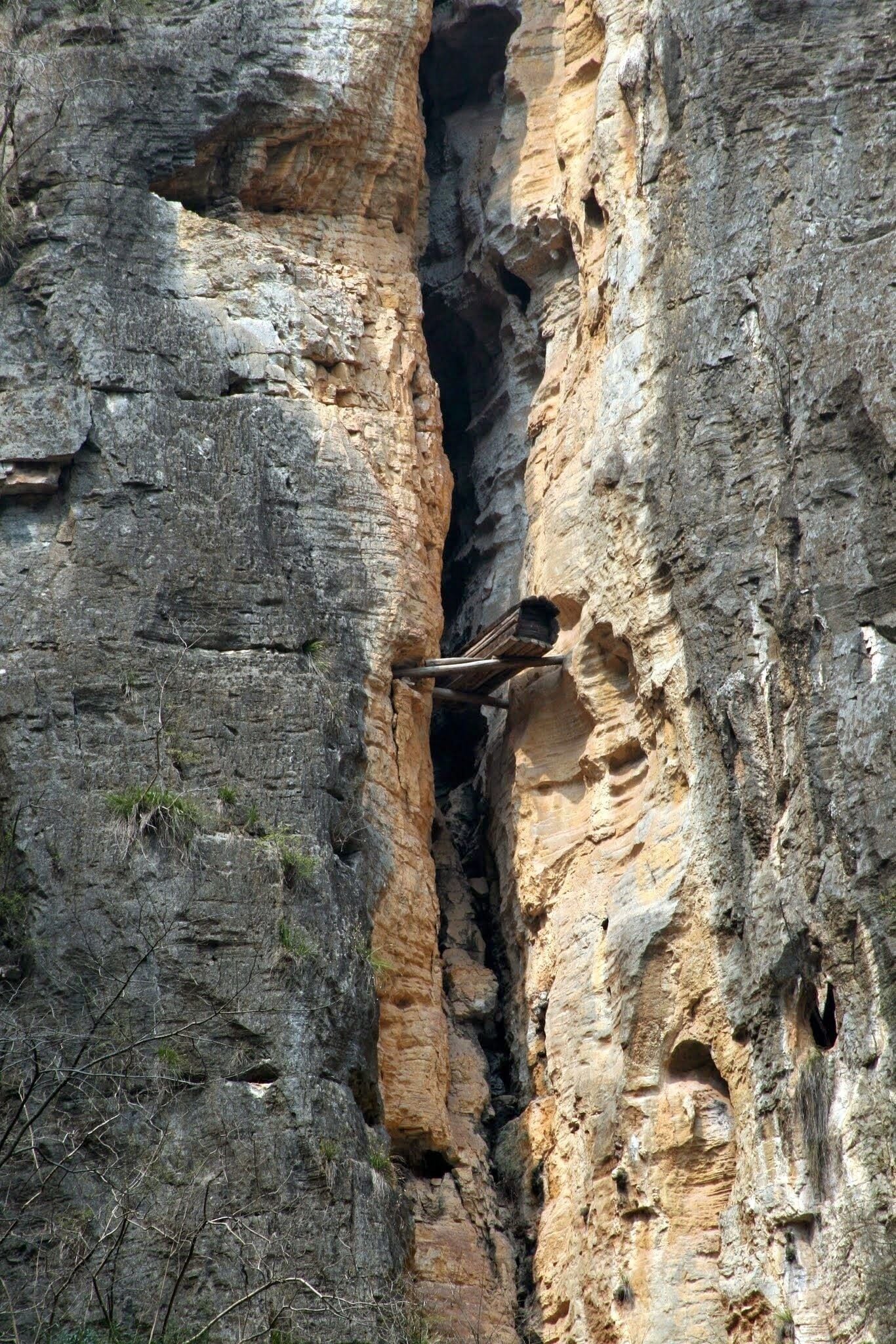 Hanging Coffins and the Shennong Stream.

Another very enjoyable excursion from our Yangtze River cruise.  The Shennong Stream is a tributary of the Yangtze.  The excursion takes you 20km up the stream through three specatacular gorges to experience the Boat Trackers - http://www.travelchinaguide.com/river/yangtze_attraction/shennong-stream.htm - they used to do this nude!
On the journey you get to see the incredible hanging coffins as pictured.  Originally, before the 3 Gorges dam flooded the gorge, these were 90 - 200m above the river surface.  They date back 2000 years and no-one is quite sure how these incredible feats of engineering were acheived.  
My picture was taken with from some distance away and this coffin is probably about 90 metres above the current river level.
More info - http://www.megalithic.co.uk/article.php?sid=17946