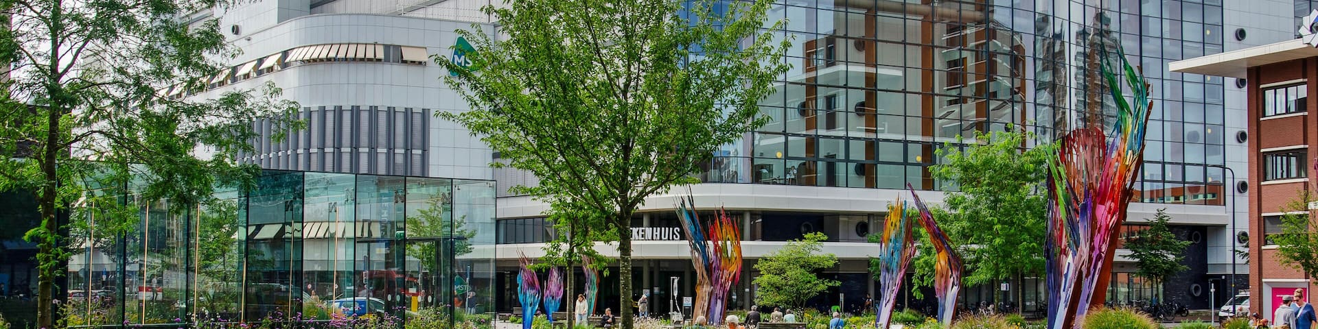 Enschede, The Netherlands, August 9, 2023: lots of greenery on central Koningsplein square with inthe background the hospital