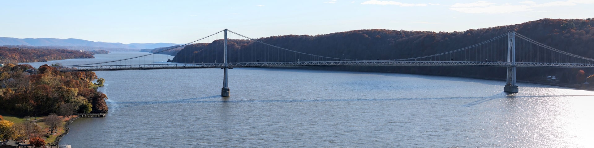 panoramic view of mid hudson bridge over hudson river valley (poughkeepsie, upstate new york) sunny day train station wide angle sun glare crossing suspension small town travel metro north