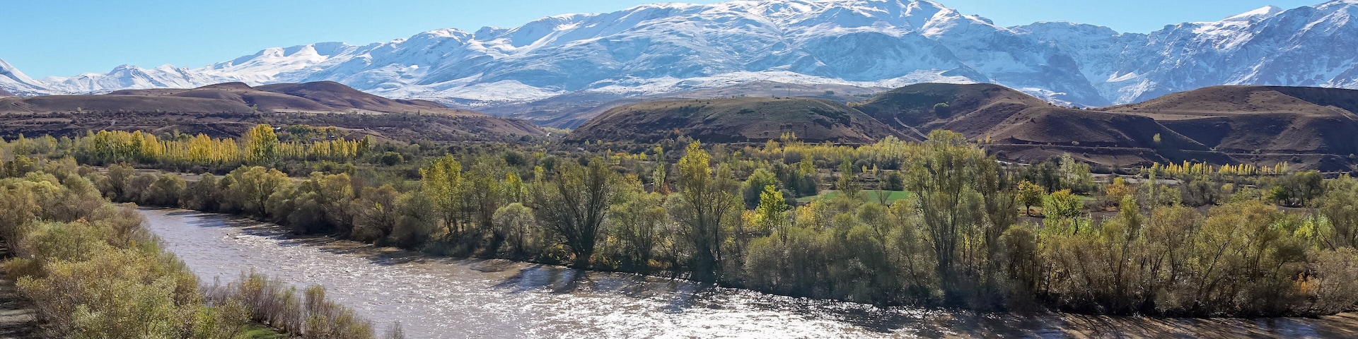 Panoramic view of a valley with snow capped mountains and River Euphrates near Erzincan, Turkey