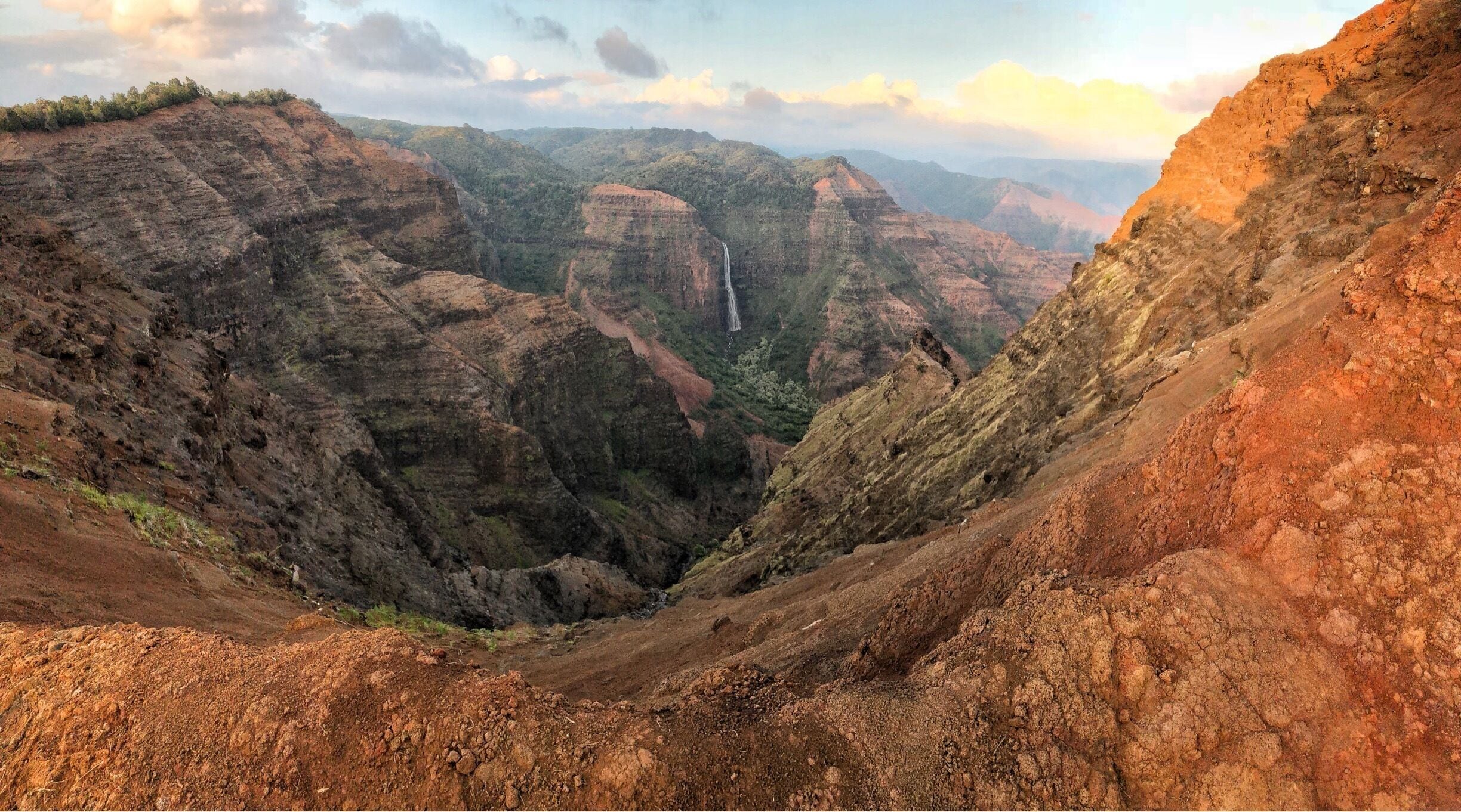 Beautiful day at Waimea Canyon on Kauai, Hawaii. If you ever go to Kauai make sure to make the drive to Waimea Canyon to see spectacular views of both the canyon and the Na Pali coast. For views of the coast you have to drive to the end of the canyon road. A lot of people make the mistake of turning around after visiting the Canyon lookout point never realizing that a beautiful view of the coast awaits at the top of the road. 