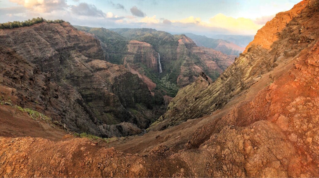 Beautiful day at Waimea Canyon on Kauai, Hawaii. If you ever go to Kauai make sure to make the drive to Waimea Canyon to see spectacular views of both the canyon and the Na Pali coast. For views of the coast you have to drive to the end of the canyon road. A lot of people make the mistake of turning around after visiting the Canyon lookout point never realizing that a beautiful view of the coast awaits at the top of the road.