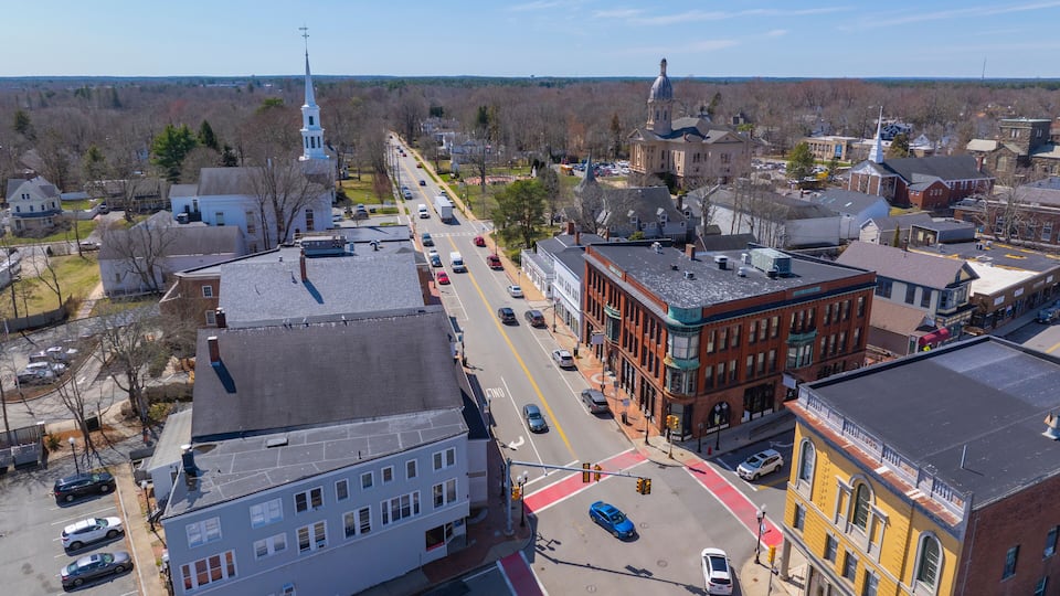 A town with historic buildings, a church, and a clear blue sky.