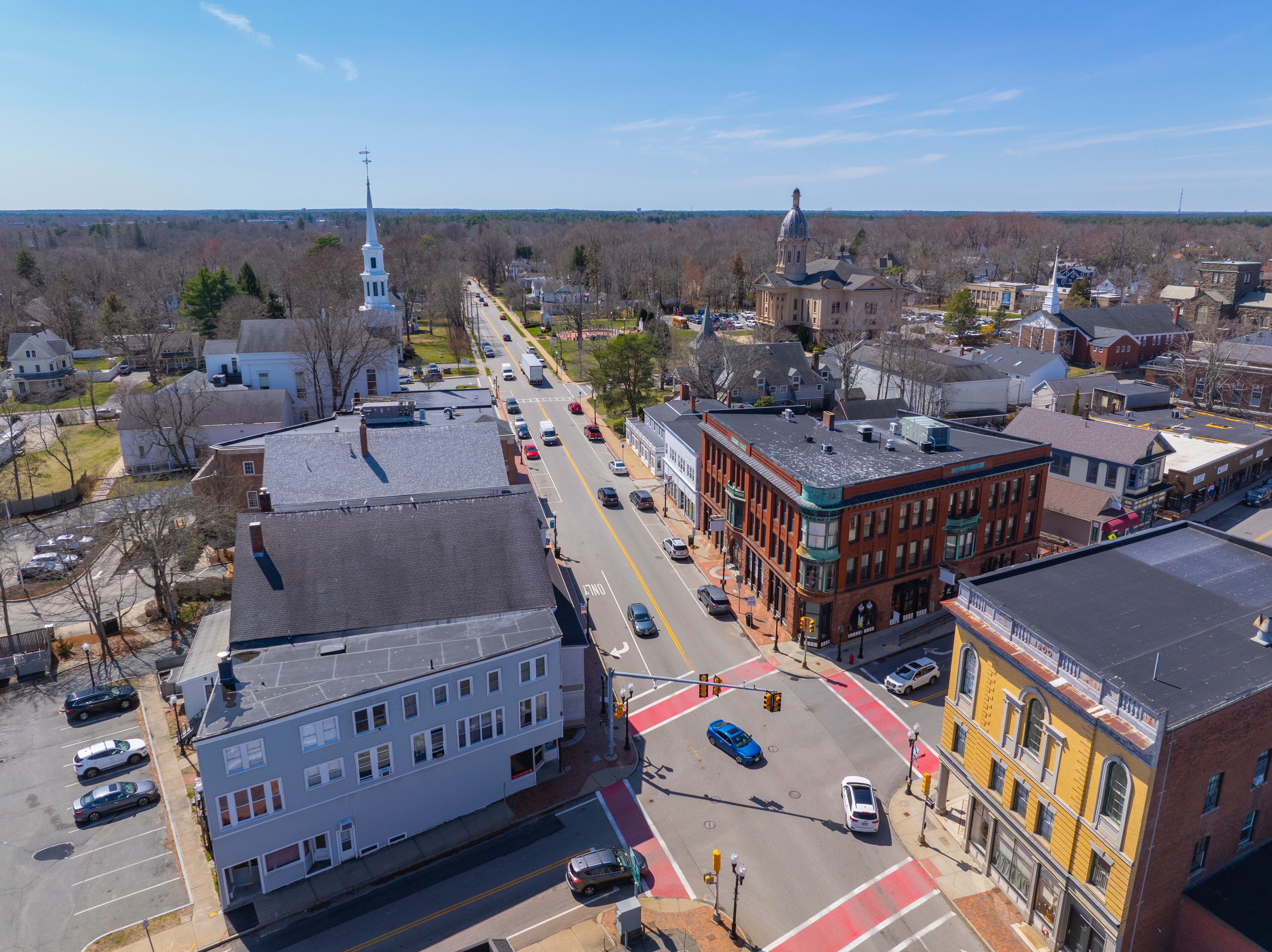 A town with historic buildings, a church, and a clear blue sky.