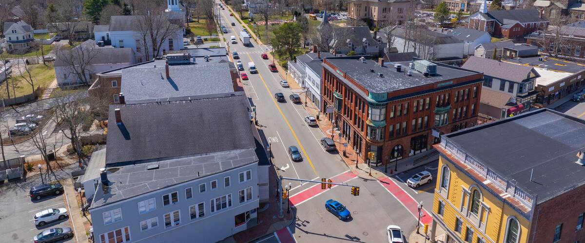 A town with historic buildings, a church, and a clear blue sky.