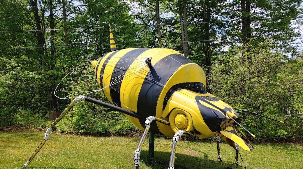 A bright black and yellow bee assembled from the front end of a car and the rear end of a cement mixer.
Schaefer's Auto Art is an amalgamation of automobile and other mechanical parts into works of giant yard art.
This place is a prime example of the fading American #culture of the roadside attraction.
Roadside attractions had their heyday with the rise of the automobile. As Americans increasingly traveled by car, many businesses had one shot to attract the attention of potential customers zipping by at higher and higher speeds.
Thus, the creation of larger than life, brightly colored, oddball sculptures along America's burgeoning highways and byways.