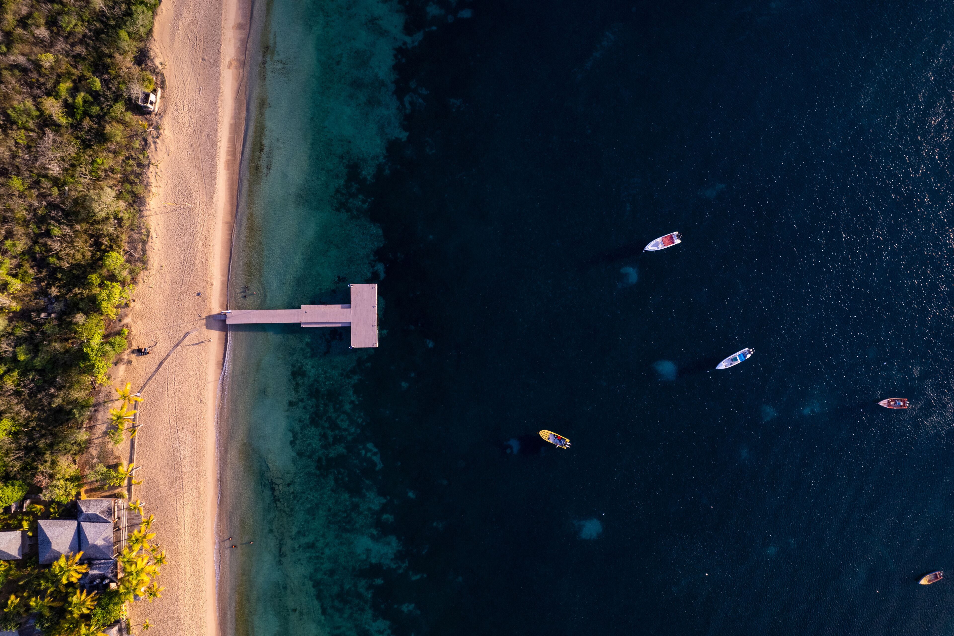 Aerial view of turquoise waters and sandy shore at Crocus Bay, Pelican Point, The Valley, Anguilla.