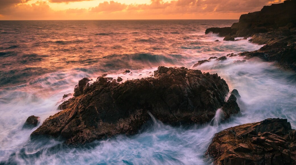 A cool bit of coastline on Aruba where you can catch the sunrise and watch the waves crash against the rocks. Just park at the light house and walk east to the cliffs. There's a small trail leading down to the water.