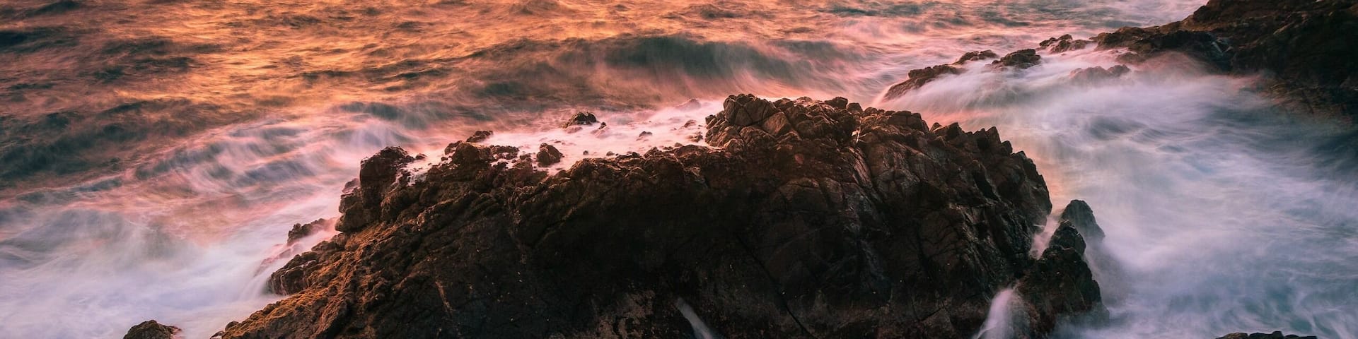 A cool bit of coastline on Aruba where you can catch the sunrise and watch the waves crash against the rocks. Just park at the light house and walk east to the cliffs. There's a small trail leading down to the water.