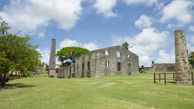 An old stone building with arched windows and a tall chimney.