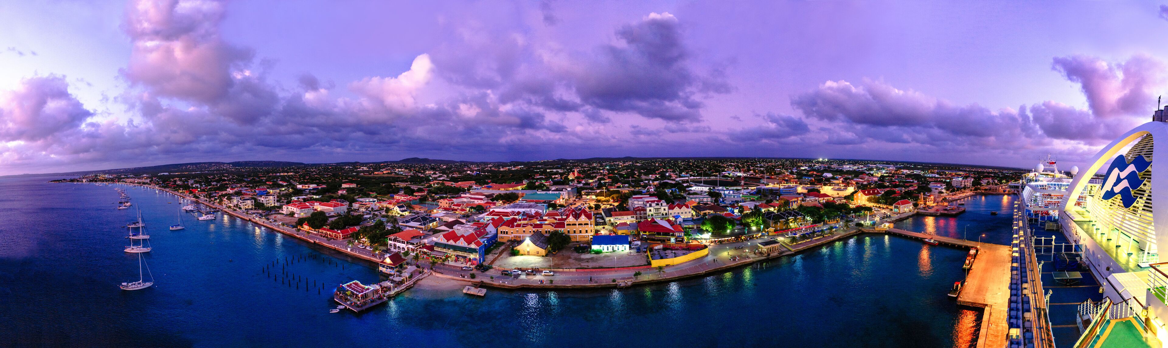 View of city against cloudy sky during sunset