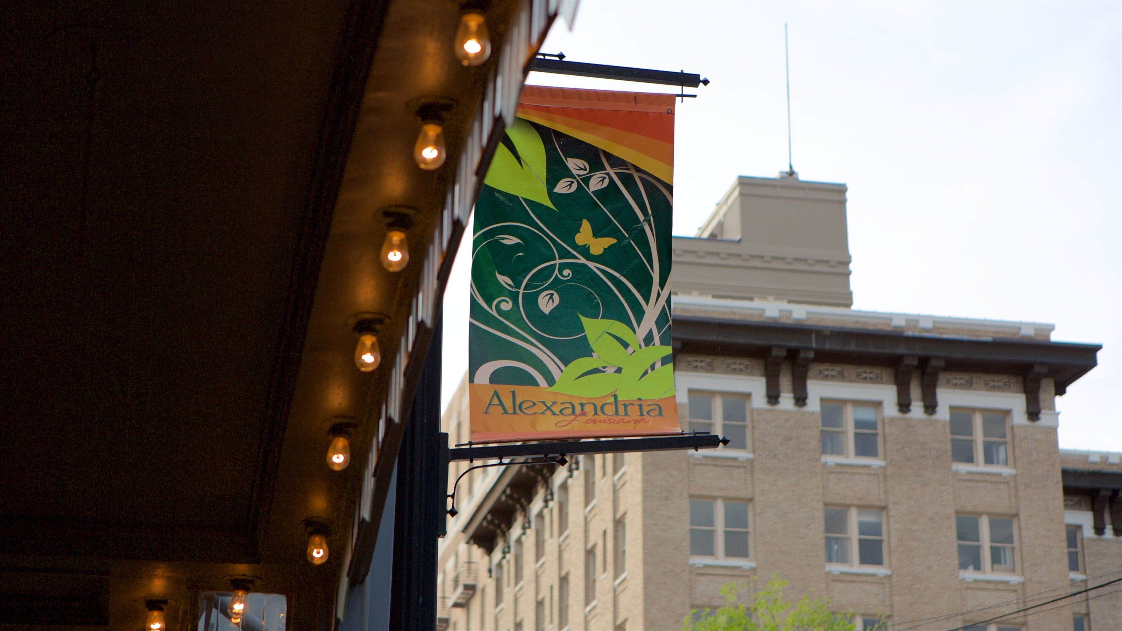 A building with a sign that reads "Alexandria" and a decorative banner with a leaf and butterfly design.
