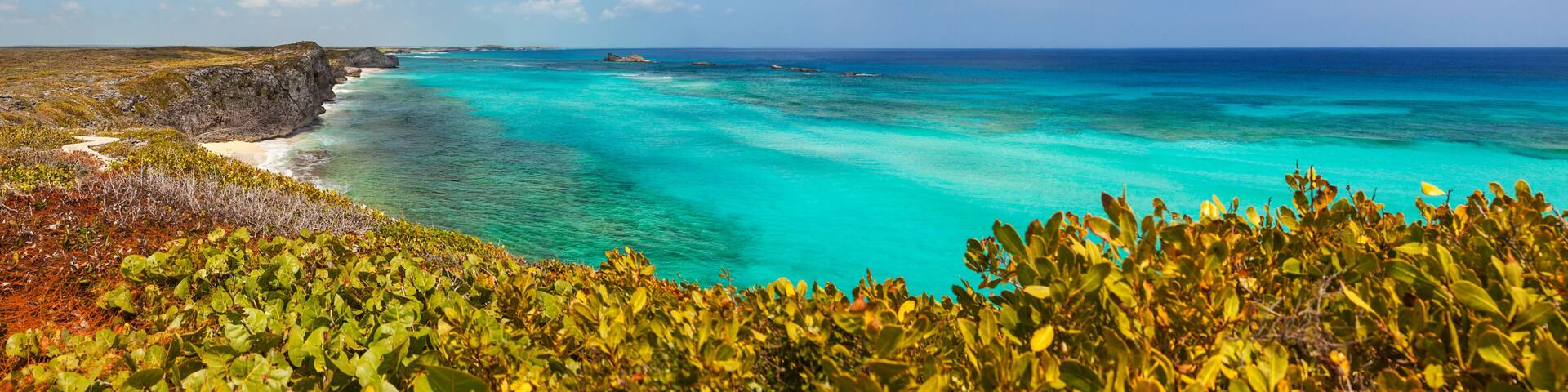 Panoramic view of the cliffs, reef and turquoise shallows at Mudjin Harbor, Middle Caicos