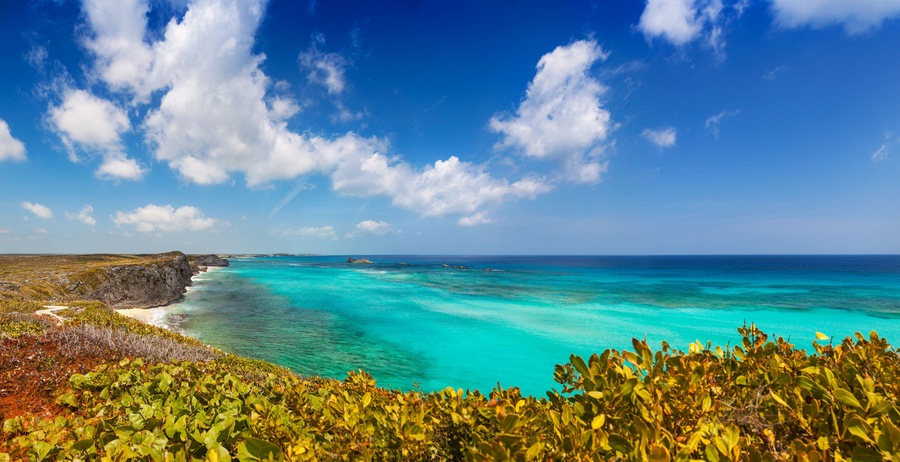 Panoramic view of the cliffs, reef and turquoise shallows at Mudjin Harbor, Middle Caicos