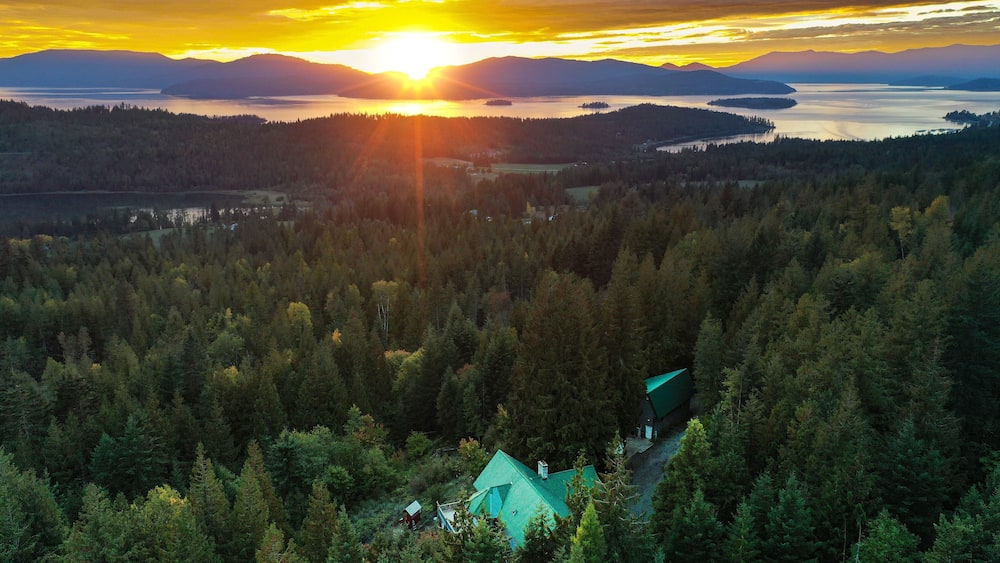 Beautiful view of the green forest and sunset above Lake Pend Oreille. Hope, Idaho, USA.