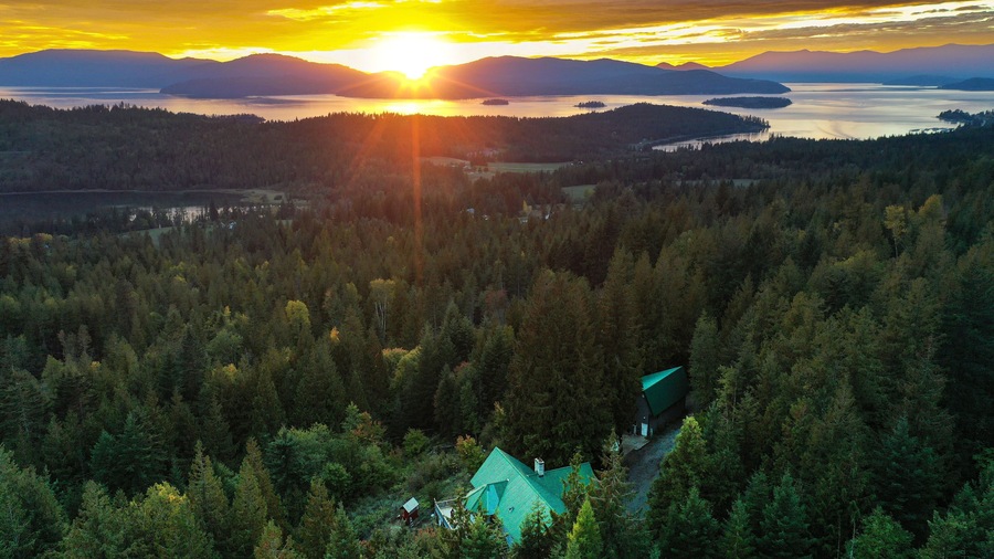 Beautiful view of the green forest and sunset above Lake Pend Oreille. Hope, Idaho, USA.