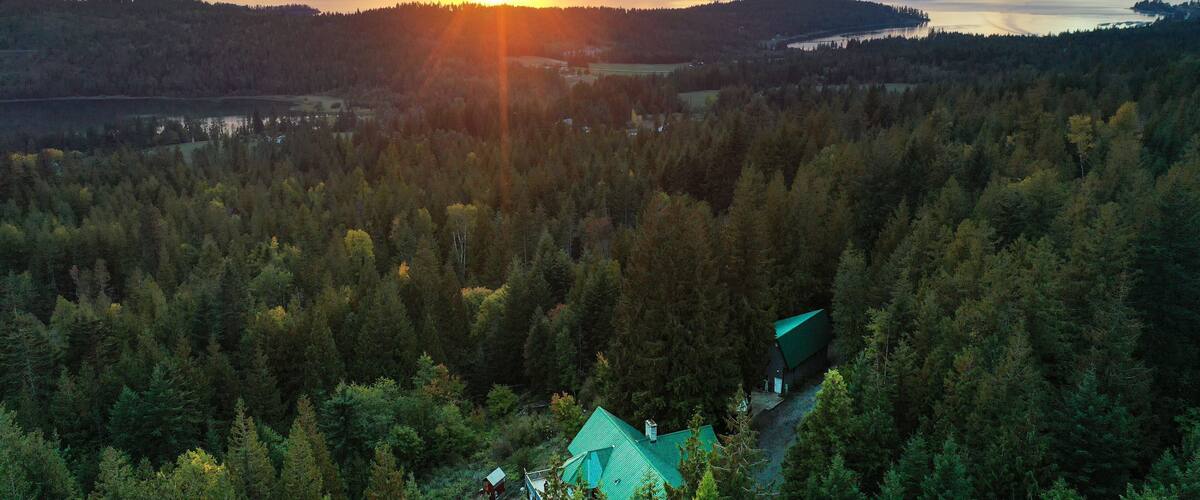 Beautiful view of the green forest and sunset above Lake Pend Oreille. Hope, Idaho, USA.