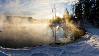 Steam rises from a natural hot spring.