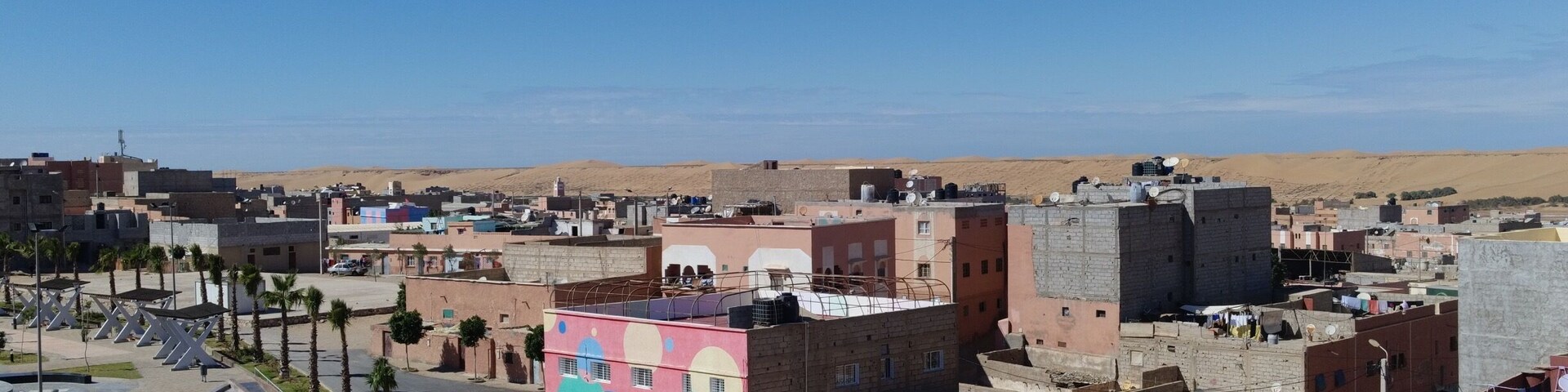 The view from our residence. Laâyoune with the desert in the background. The brightly painted building is the local school. #FindingTheUniverse #Morocco #Morac #WesternSahara