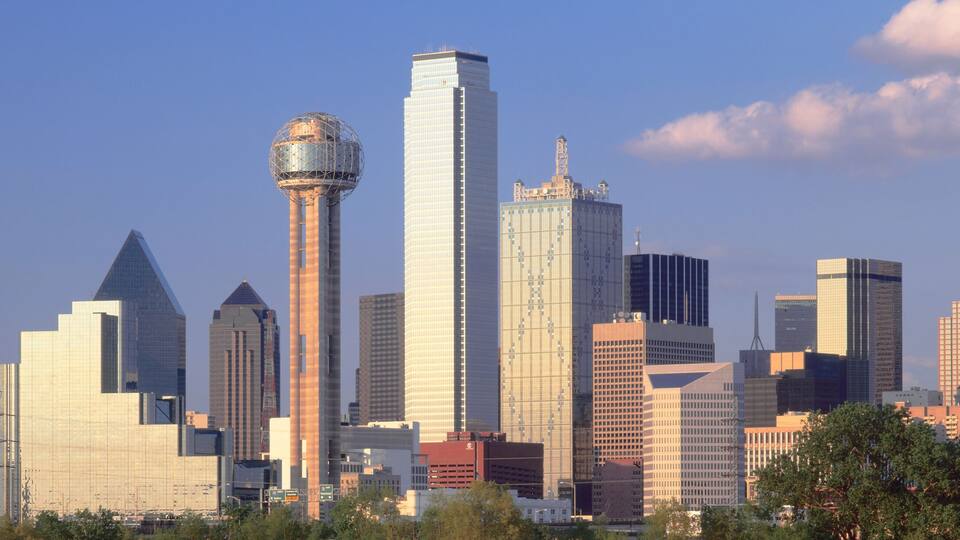 A city skyline with a variety of high-rise buildings, including a distinctive tower with a spherical structure on top.