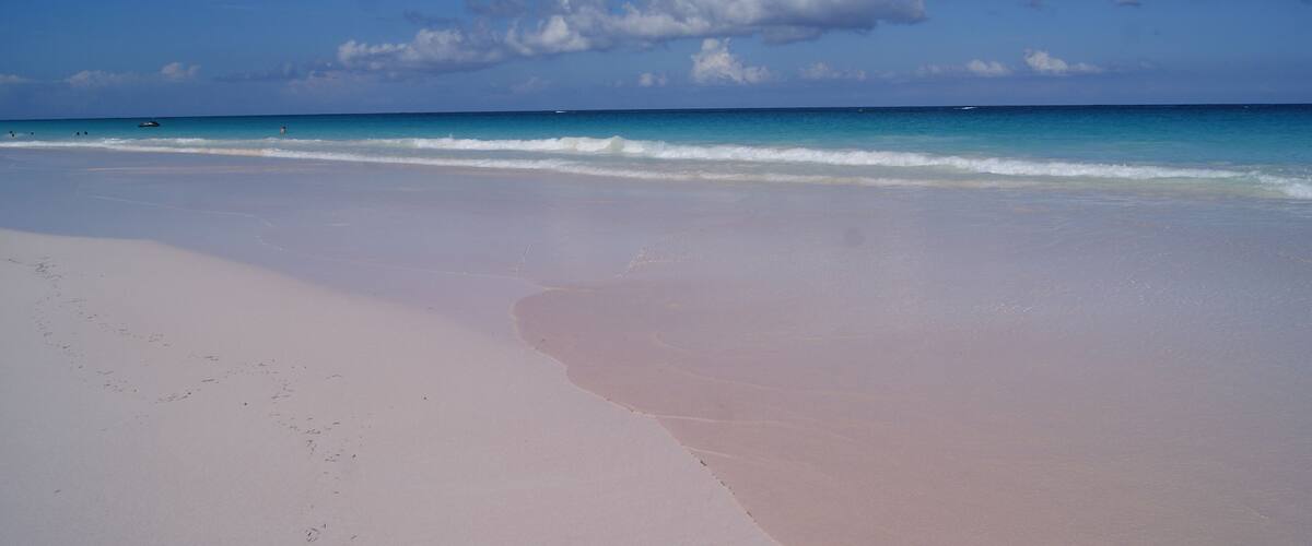 A beach with a clear sky and gentle waves.