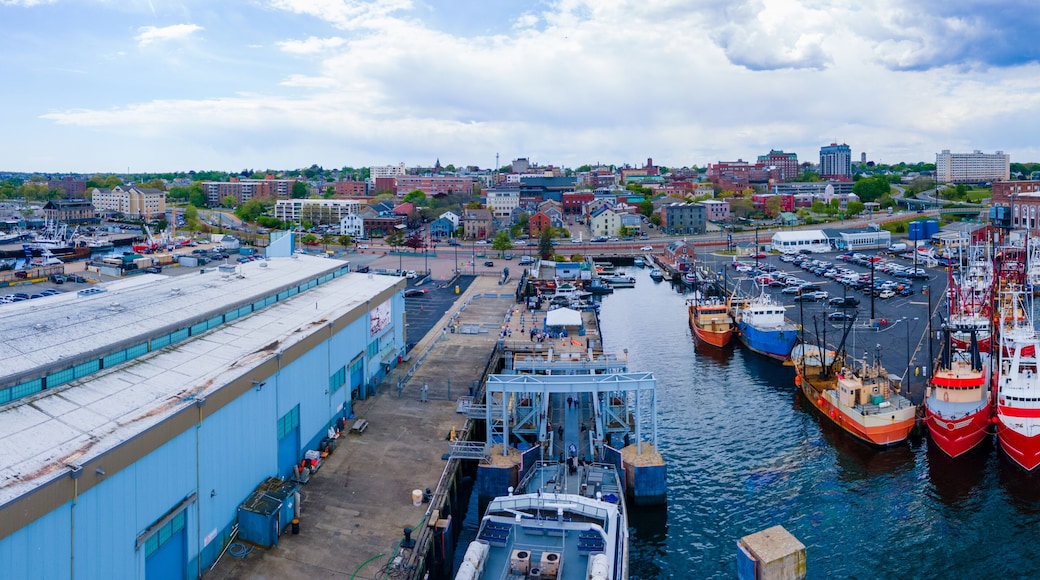New Bedford harbor panorama aerial view with fishing boats docked at piers and historic downtown of New Bedford at the background, Massachusetts MA, USA.