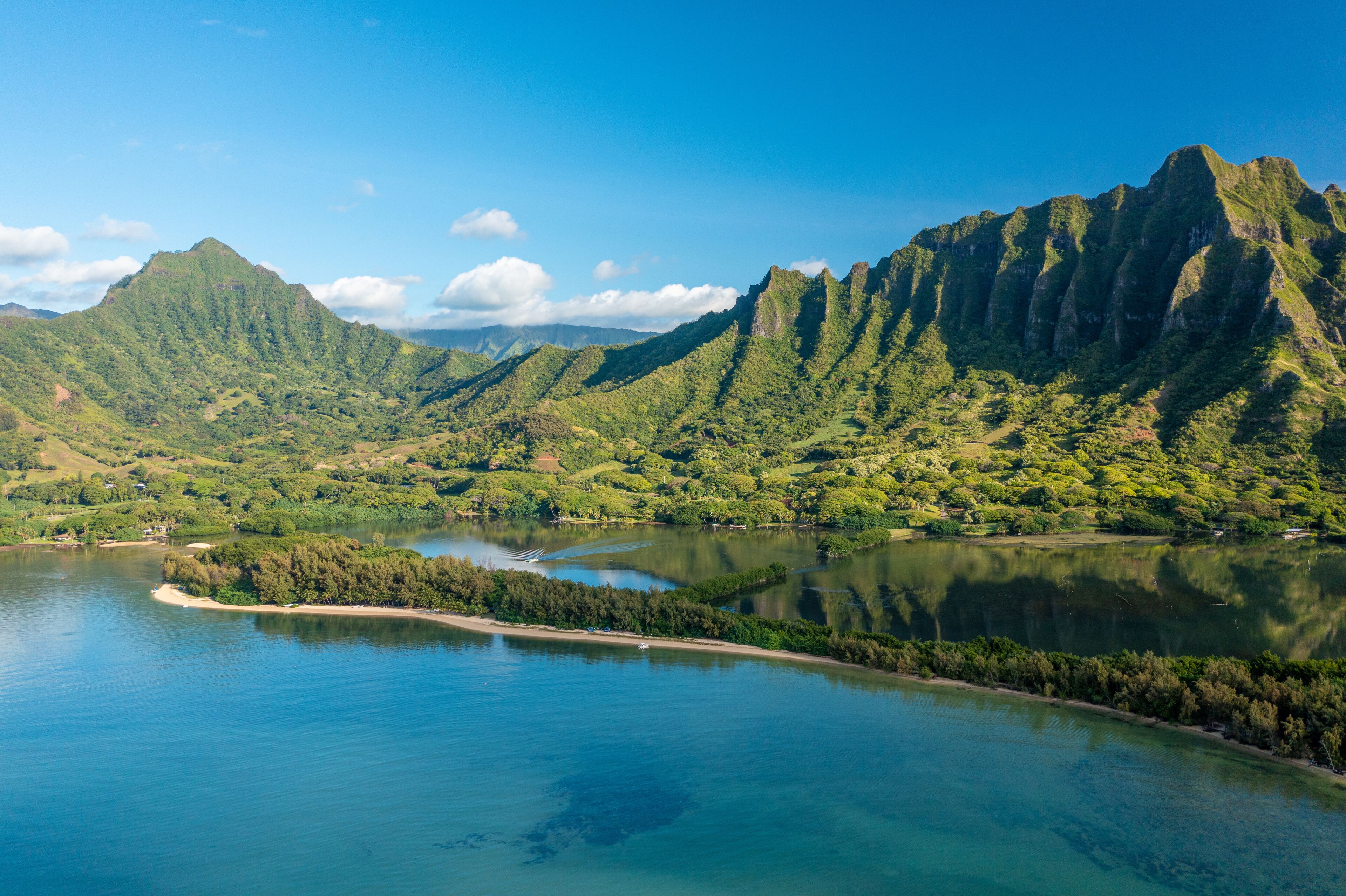 Aerial view of the ancient Moli'i fishponds with reflections of the Koolau mountains in the ponds. The ponds are located near Kaneohe, on the island of Oahu, Hawaii, USA.